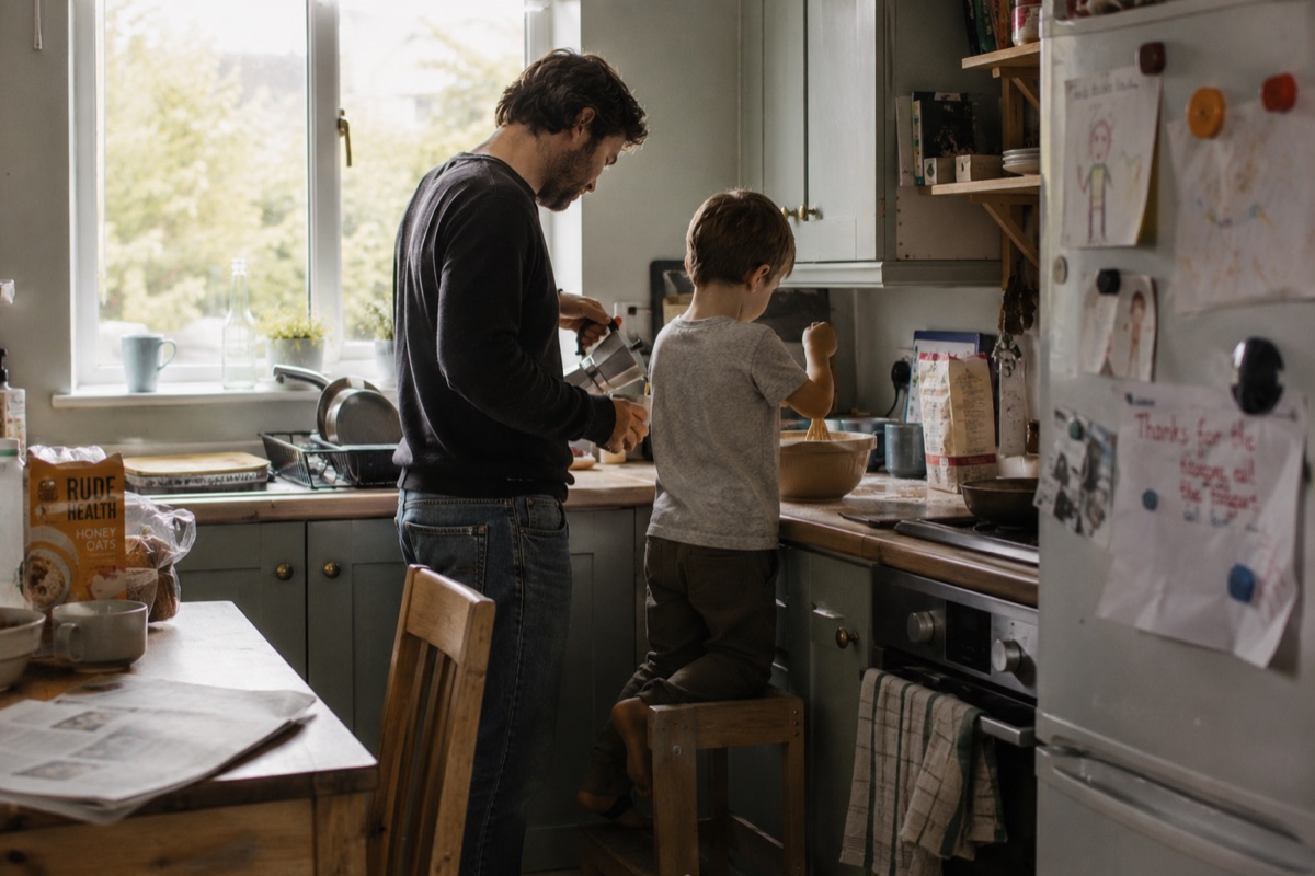 A father and son sharing an everyday moment together in the kitchen